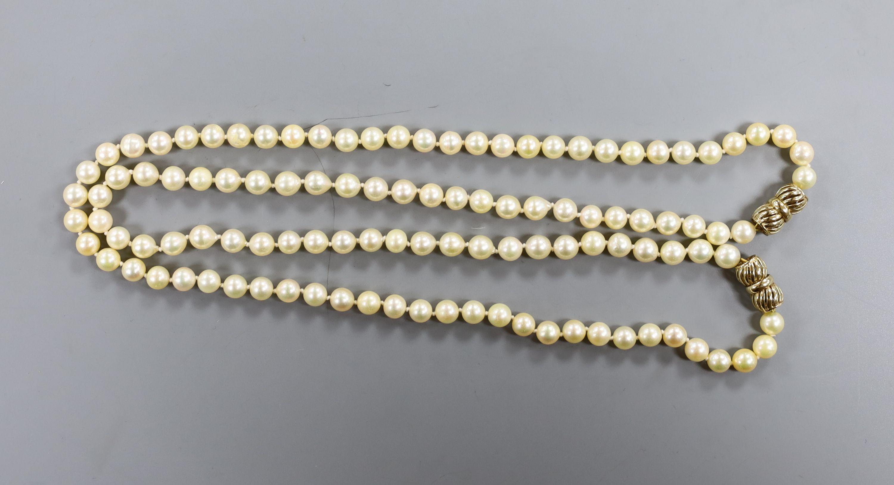 Two single strand cultured pearl necklaces, with 9ct clasps, (can be worn as one), overall 88cm.